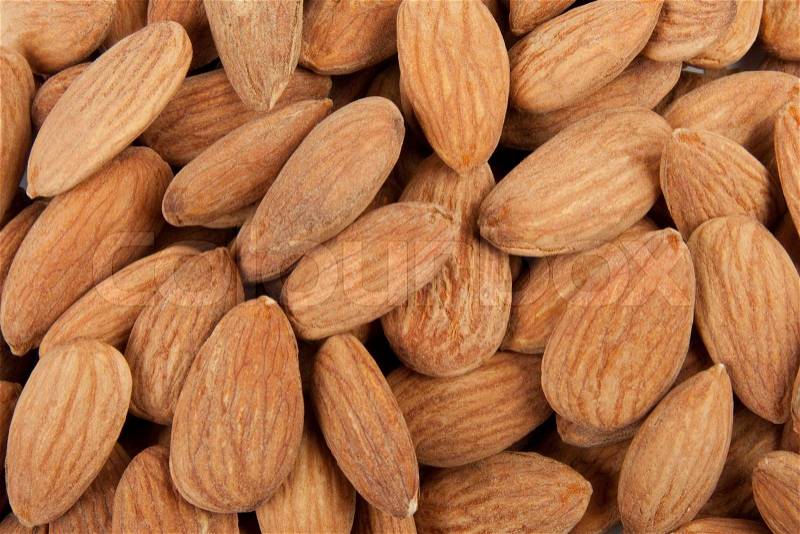 Fresh salted almonds texture background, stock photo