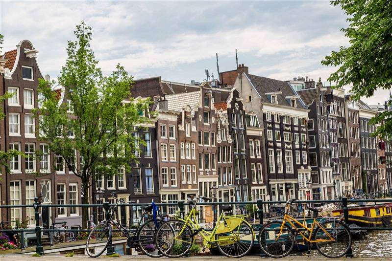 AMSTERDAM, NETHERLANDS - AUGUST 19: Bicycles on a bridge over the canals of Amsterdam. Amsterdam is the capital and most populous city of the Netherlands on August 19, 2014, stock photo