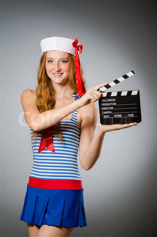 Young woman sailor with movie board, stock photo