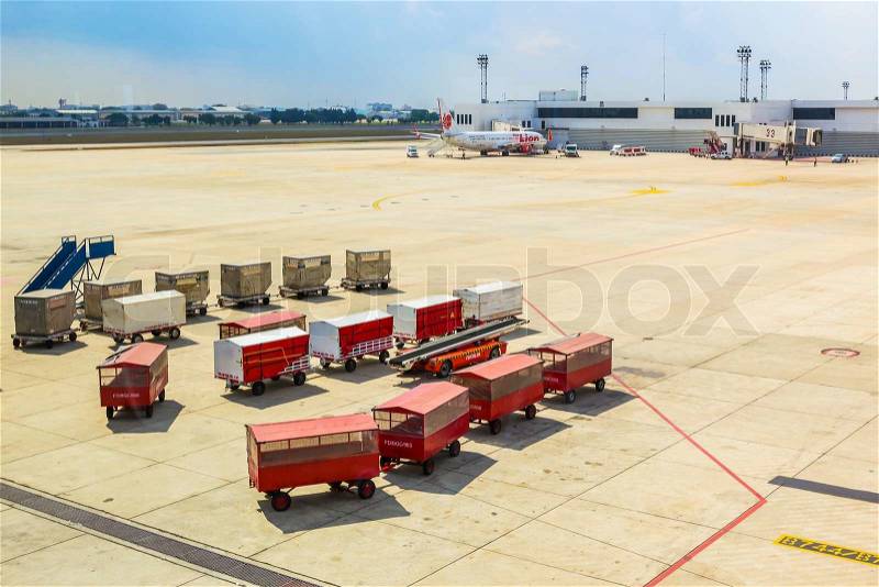 BANGKOK THAILAND - FEBRUARY 8: Airport terminal names Don Muang prepare luggage and goods for passenger transportation in Bangkok, Thailand on February 08, 2014, stock photo