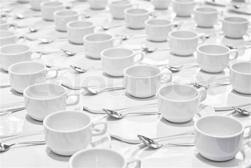 Stacks of coffee cups with silver teaspoons prepare for meeting, stock photo