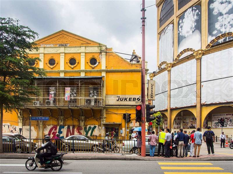 KUALA LUMPUR, MALAYSIA - NOVEMBER 14, 2014 : People crossing street over Grecian-Spanish style buildings background at Little India in Kuala Lumpur, Malaysia, stock photo
