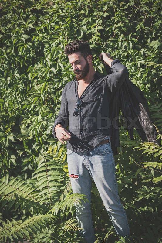 Young handsome attractive bearded model man in urban context, stock photo