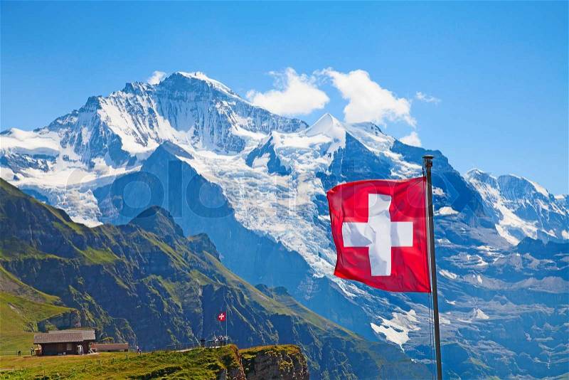 Swiss flag on the top of Mannlichen (Jungfrau region, Bern, Switzerland), stock photo