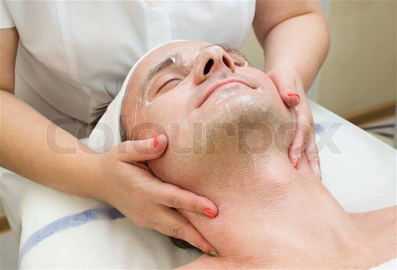 Man in a beauty salon facial and massage, stock photo