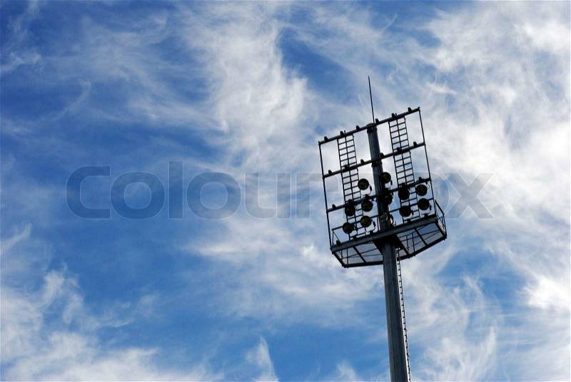 Soccer stadium floodlights. View from below against a summer sunset sky, stock photo
