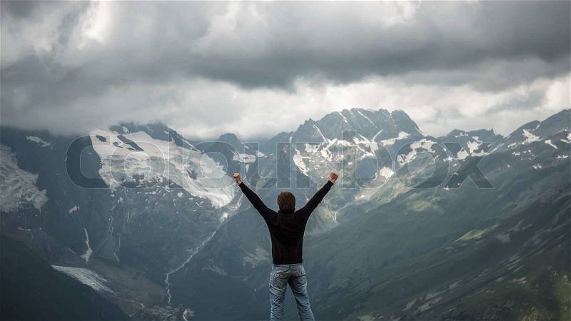 Happy traveller on the top of mountain stormy landscape, stock photo