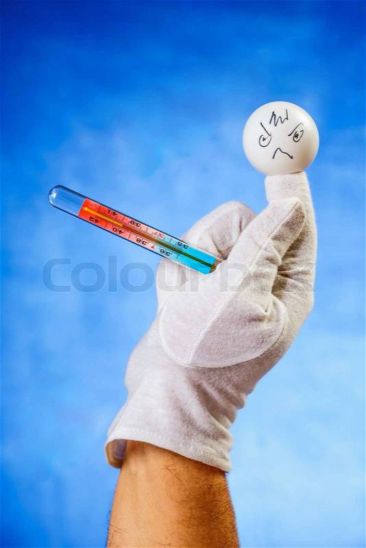 Concept of illness: finger puppet with medical thermometer showing 39,8 degrees celsius, stock photo