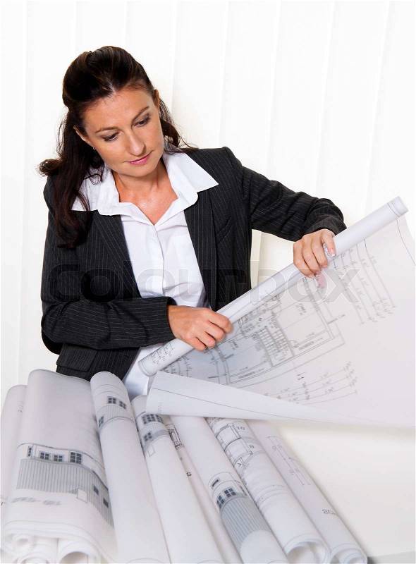 Architect with blueprint in the office. Squares ne a house will be processed, stock photo