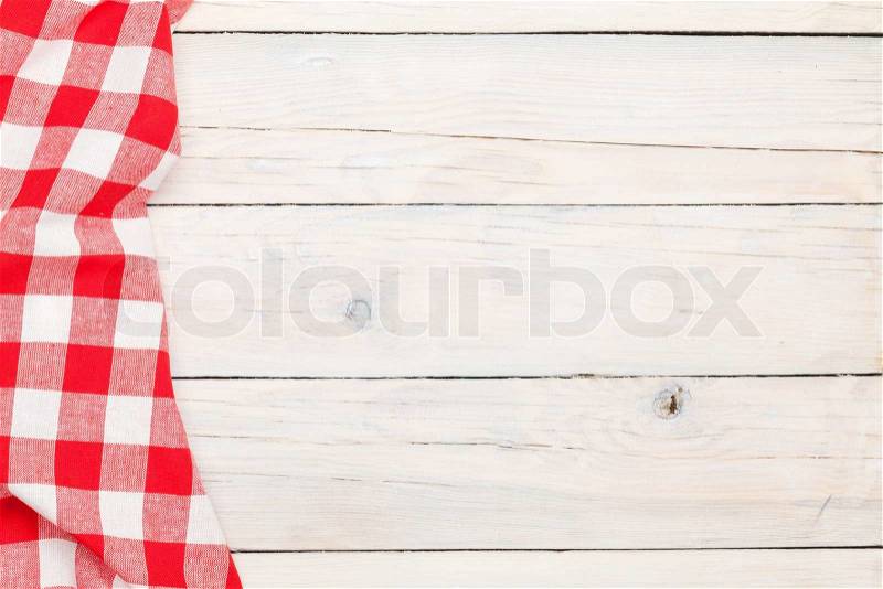 Red towel over wooden kitchen table. View from above with copy space, stock photo