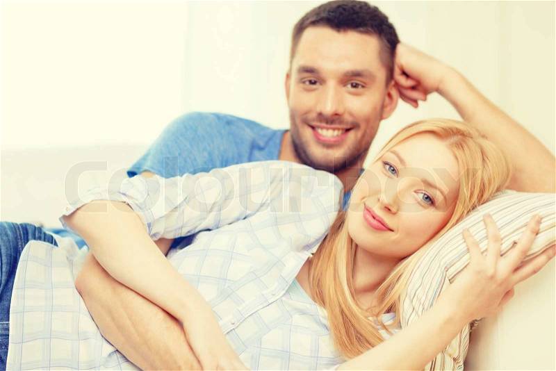 Love, family and happiness concept - smiling happy couple at home, stock photo