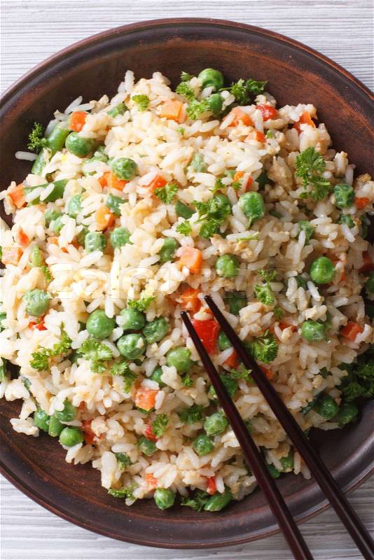Asian fried rice with egg and vegetables closeup. top view vertical\, stock photo