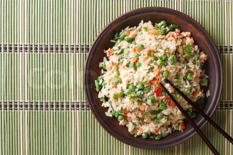 Japanese fried rice with egg and peas close-up on a plate. top view of a horizontal , stock photo