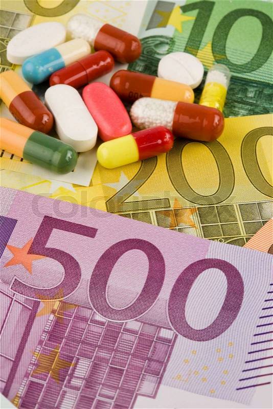 Euro bank notes and tablets. Image Medienkamente, medicine and health costs, stock photo