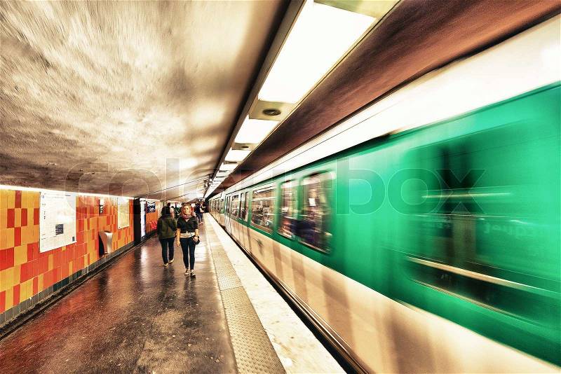 PARIS - MAY 23, 2014: Paris Metro station with fast moving train in Paris, France. Paris Metro is the 2nd largest underground system worldwide by number of stations (300), stock photo