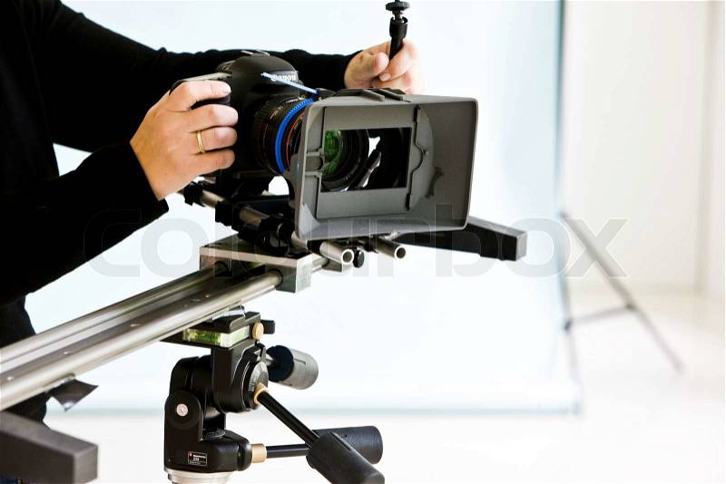A photographer in a studio with high-end camera for photoshoot (stock photo), stock photo