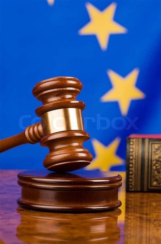 A gavel in court. With a European flag in the background, stock photo