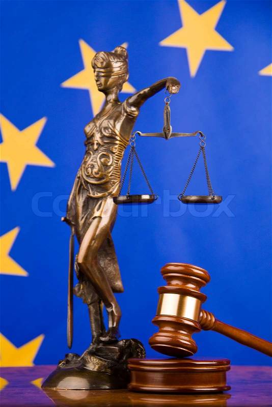 A gavel in court. With a European flag in the background, stock photo