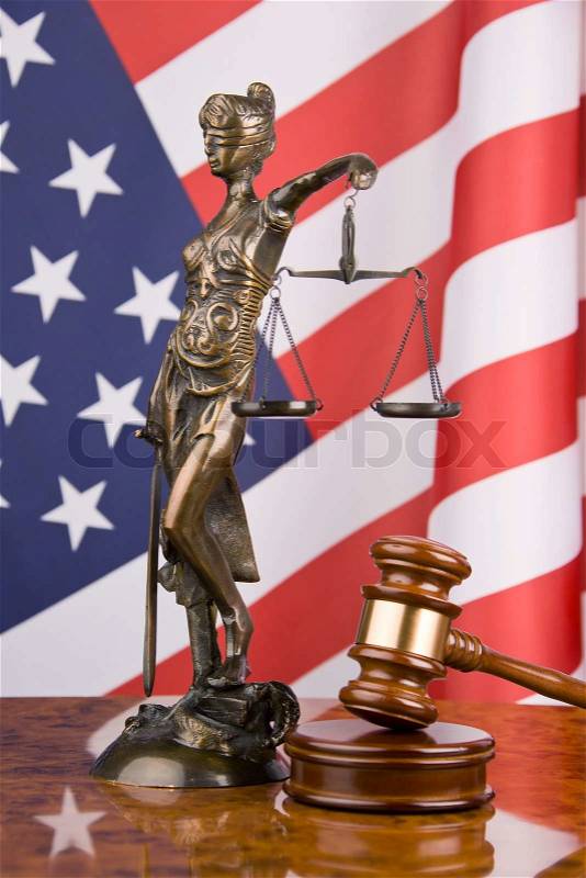 A gavel in court. With an American flag in the background, stock photo