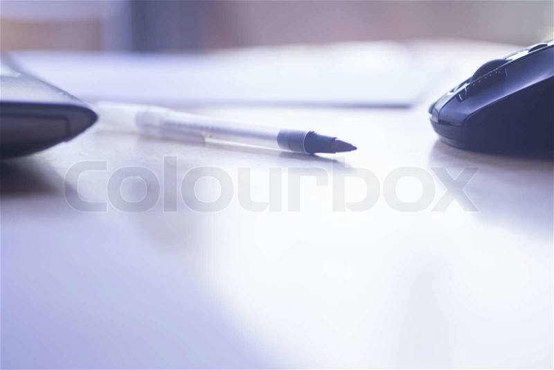 Artistic color photo of a laptop pc computer. biro pen and wifi mouse on office work desk table. , stock photo