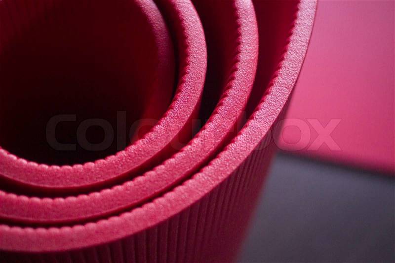 Red fitness, yoga and pilates foam mats in sports aerobics gymnasium. Artistic photo. , stock photo