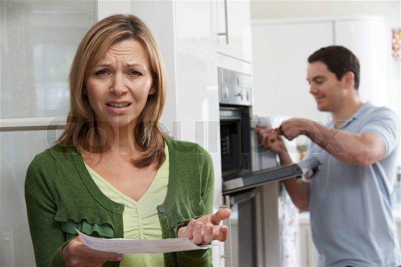 Unhappy Female Customer With Oven Repair Bill, stock photo
