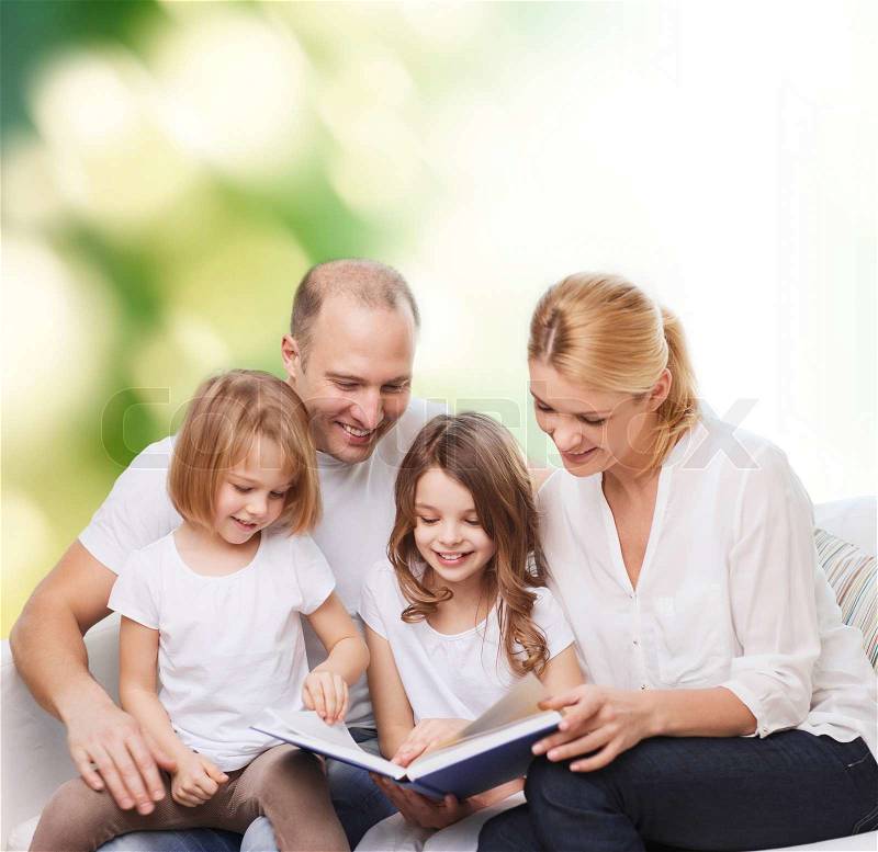 Family, childhood, ecology and people - smiling mother, father and little girls reading book over green background, stock photo