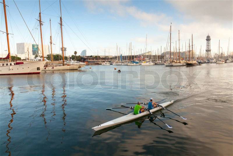 Barcelona, Spain - August 26, 2014: Twin sport racing rowing boat goes in Vista port harbor, stock photo