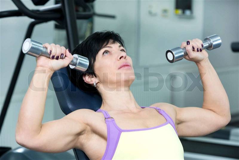 Adult female bodybuilding competitions in the gym, stock photo