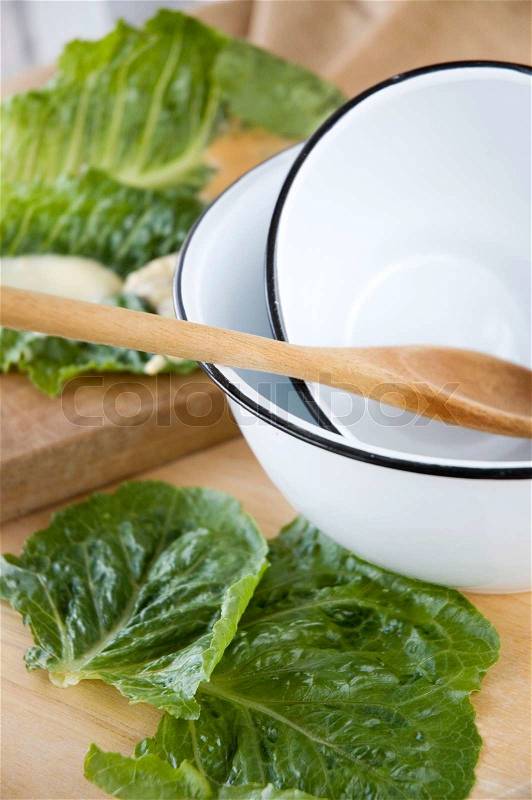 Close up white bowl kitchenware with fresh veggie in background, stock photo
