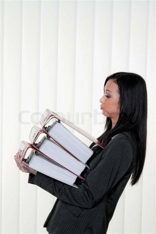 Overburdened women with stress and files in the office. Symbol of bureaucracy, stock photo