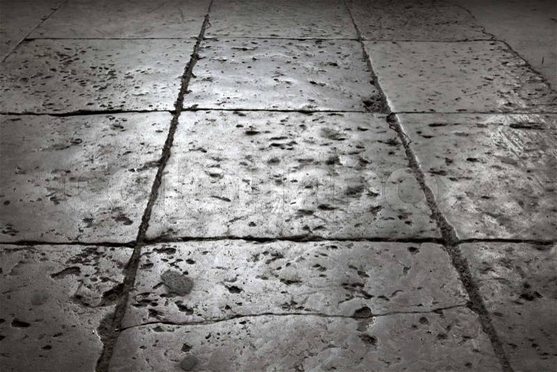 Dark gray stone tiling on the floor, background with perspective effect, stock photo