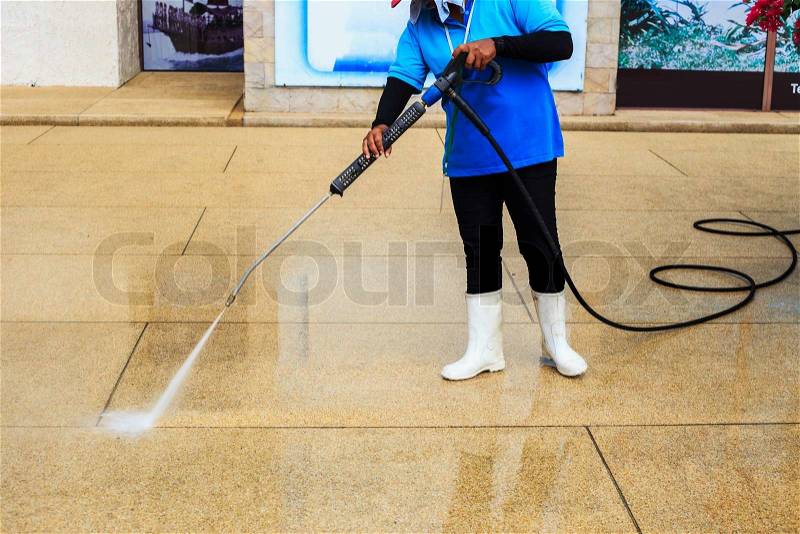 Floor cleaning with high pressure water jet, stock photo