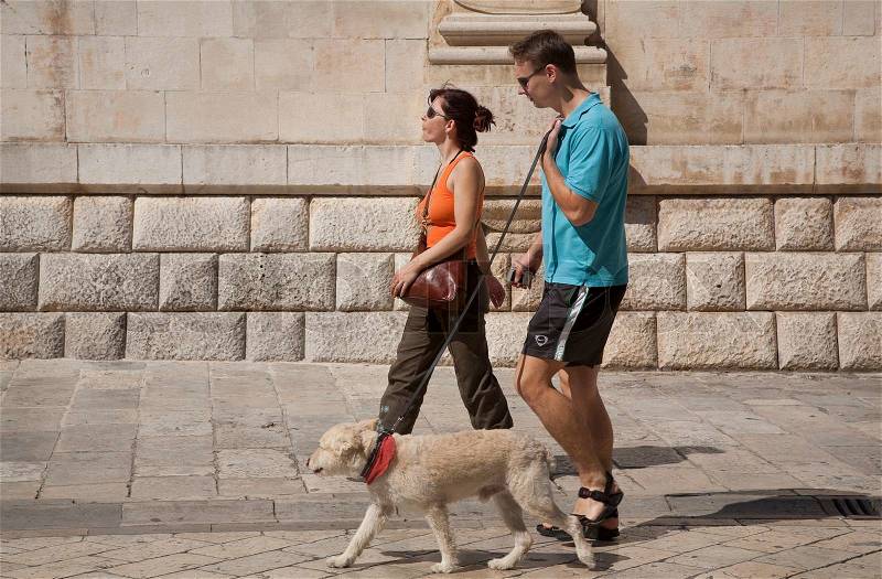 Walking the dog in the old city of Dubrovnik, stock photo