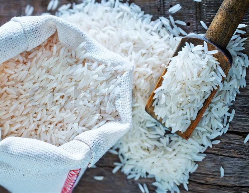 Raw rice in bag and on a table, stock photo