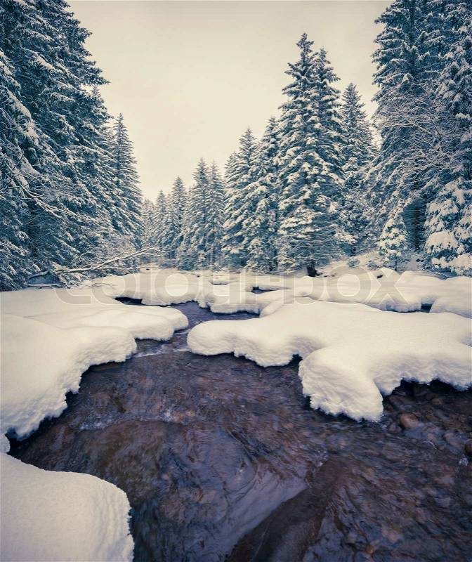 Dark river in the winter mountain forest. Retro style, stock photo