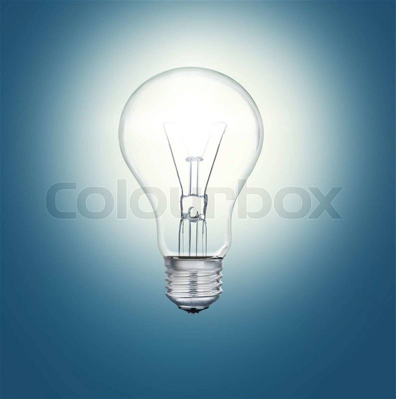A light bulb shines in the darkness bright light, stock photo
