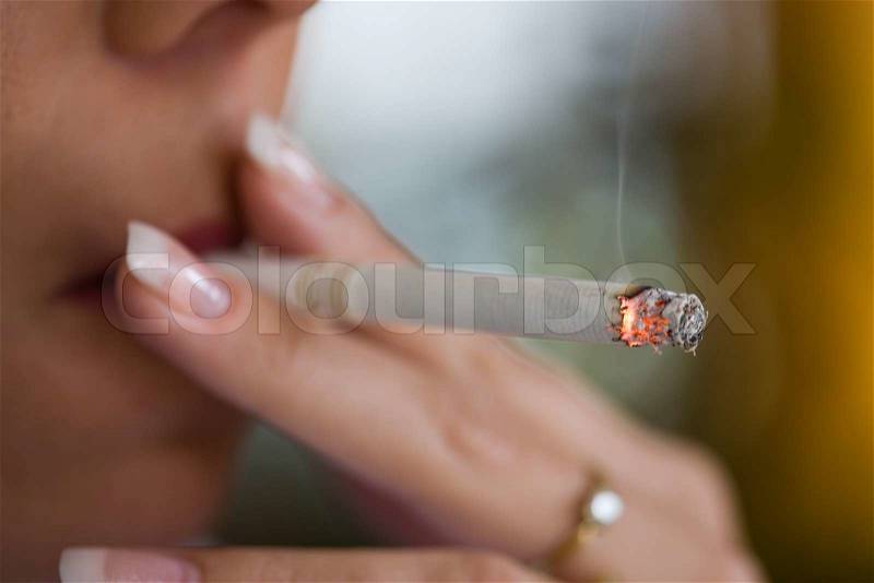 A young woman smoking a cigarette. Smoking Women, stock photo