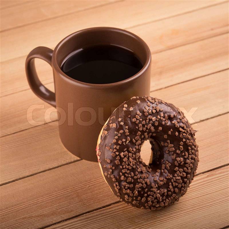 Chocolate donut and cup of coffee, stock photo