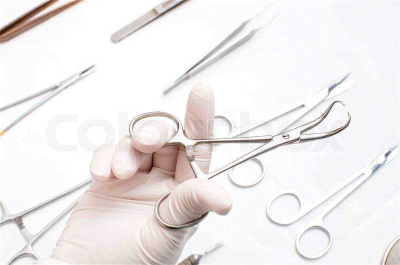 Metallic surgical instrument in the surgeon\'s hand, stock photo