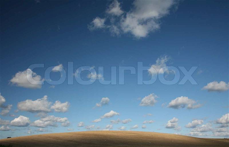Desert under summer sky with nice cloud formation, stock photo