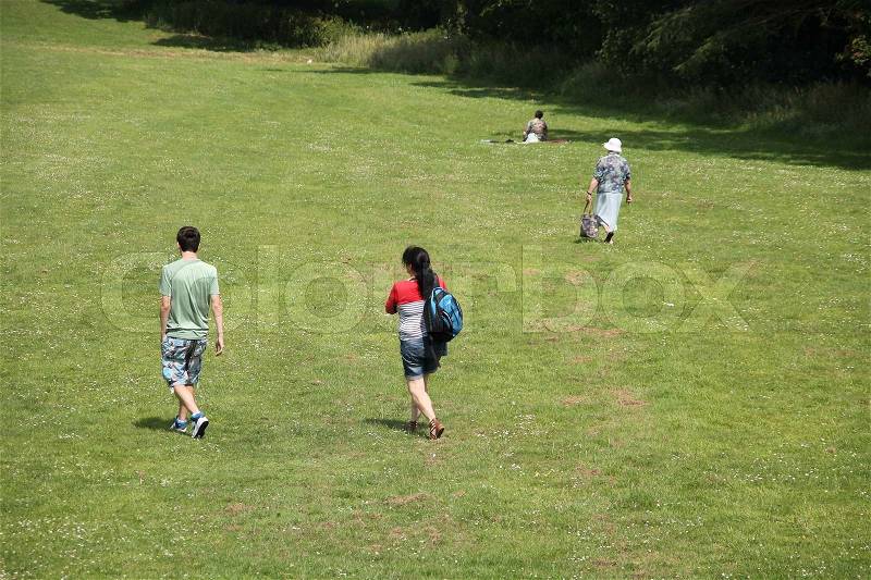 The population walk in the grass on the mount in the summer in England, stock photo
