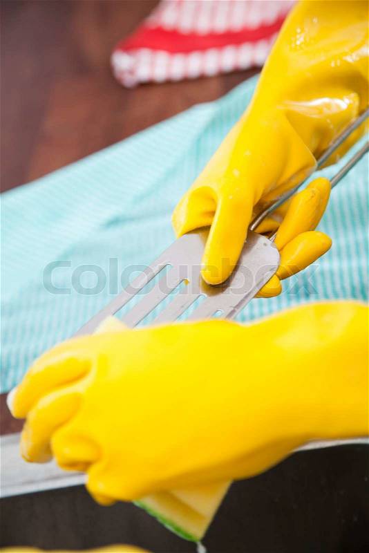 Girls cleaning dirty kitchen wares, stock photo