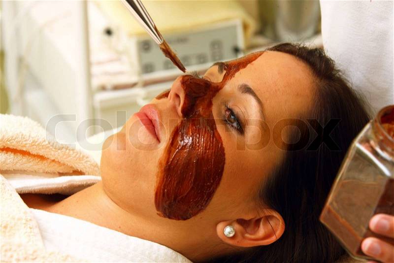 Apply a facial mask made of chocolate in a spa hotel, stock photo