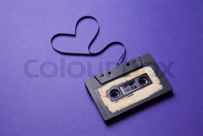 Audio cassette with magnetic tape in shape of heart, stock photo