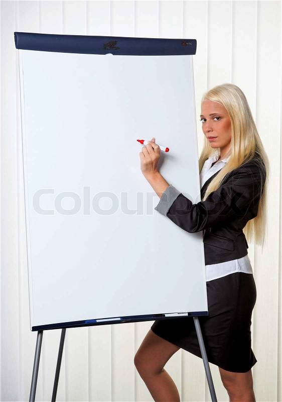 Young business woman on a flip chart created graph, stock photo