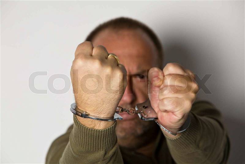 Man handcuffed. Symbol for detention and removal, stock photo