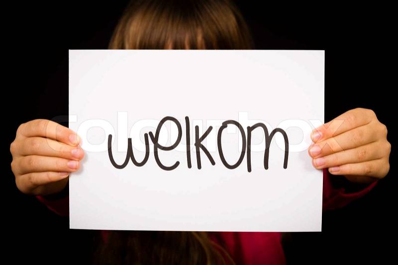 Studio shot of child holding a sign with Dutch word Welkom - Welcome, stock photo