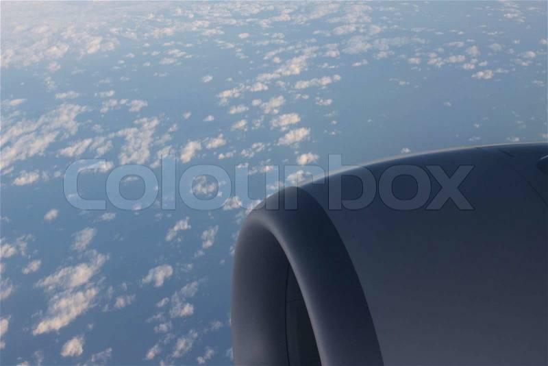 Airplane flying in sky in flight engine wing, stock photo