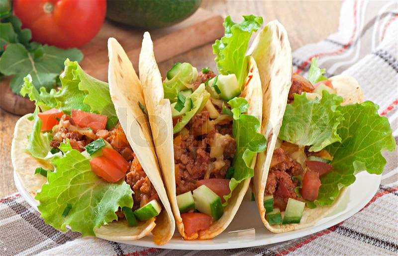 Mexican tacos with meat, vegetables and cheese, stock photo